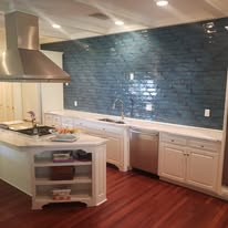 Full kitchen remodel with hand-set tile backsplash and hardwood floors.