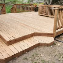 Custom cedar deck with classic picket railing and stepped landing.
